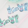 Franken-Love stickers feature zombie hands in various colors and positions spelling out "LOVE YOU" in American Sign Language, complete with stitches, protruding bones, and long, painted nails against a backdrop of pastel-colored objects.