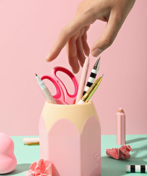 Pink stand with stationery inside on a pink backgroun