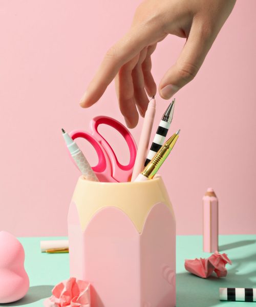 Pink stand with stationery inside on a pink backgroun